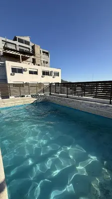 a pool of water in front of a building at Serena in Villa Carlos Paz