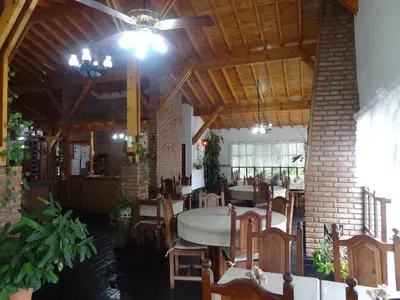 a dining room with tables and chairs in a building at Hostería Lida in Merlo