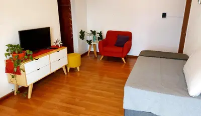 a bedroom with a bed and a tv and a chair at Espacio C Av Marcelo t de Alvear Vista Centro in Cordoba