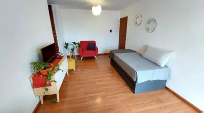 a bedroom with a bed and a tv and a chair at Espacio C Av Marcelo t de Alvear Vista Centro in Cordoba