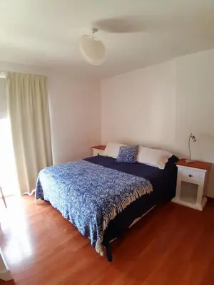 a bedroom with a bed with a blue comforter at Espacio C Av Marcelo t de Alvear Vista Centro in Cordoba