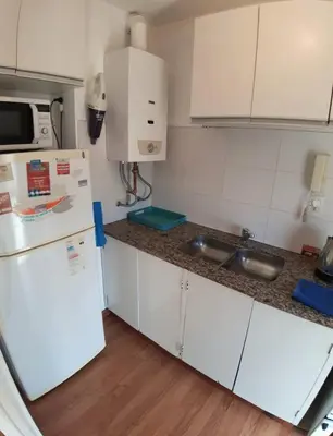 a kitchen with a white refrigerator and a sink at Espacio C Av Marcelo t de Alvear Vista Centro in Cordoba