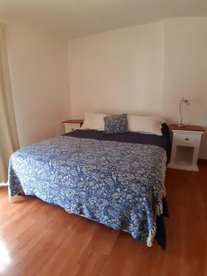 a bedroom with a bed with a blue comforter at Espacio C Av Marcelo t de Alvear Vista Centro in Cordoba