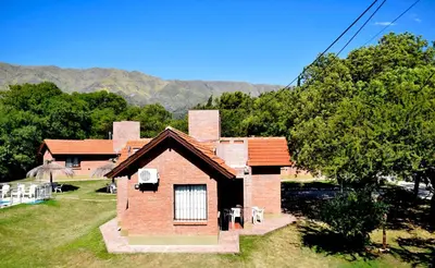 a brick house with two chimneys on top of it at Cabañas Babin Kuk in Merlo