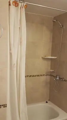 a bathroom with a shower with a white shower curtain at Colón in Cordoba