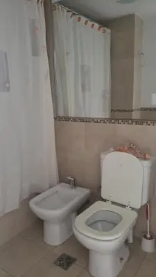 a bathroom with a toilet and a bidet at Colón in Cordoba