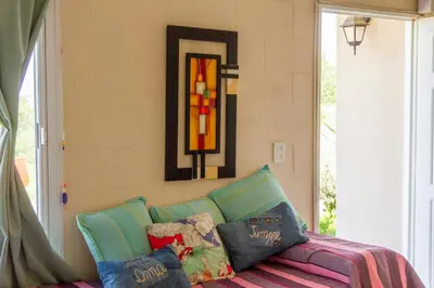 a room with a couch with pillows and a stained glass window at Complejo Utopia-Chacras de la Primavera, Tanti in Tanti