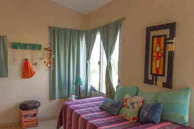 a bedroom with a bed and a window at Complejo Utopia-Chacras de la Primavera, Tanti in Tanti