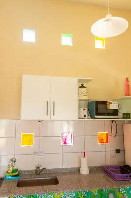 a kitchen with white cabinets and a sink at Complejo Utopia-Chacras de la Primavera, Tanti in Tanti