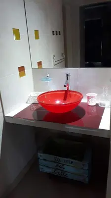 a red sink on a counter in a bathroom at Complejo Utopia-Chacras de la Primavera, Tanti in Tanti