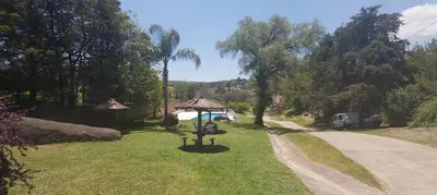a grassy yard with a gazebo and a road at Departamentos Carlos Paz bajada al lago in Villa Carlos Paz