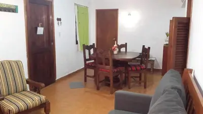 a living room with a table and chairs at Departamentos Carlos Paz bajada al lago in Villa Carlos Paz