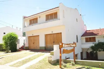 a house with a street sign in front of it at Departamentos Carlos Paz bajada al lago in Villa Carlos Paz