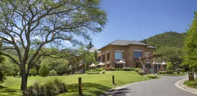 a house on a hill with a road at Altos de Belgrano Hotel Cabañas Golf y Spa in Villa General Belgrano