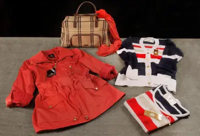 a pile of clothes and a backpack and a red jacket at Altos de Belgrano Hotel Cabañas Golf y Spa in Villa General Belgrano