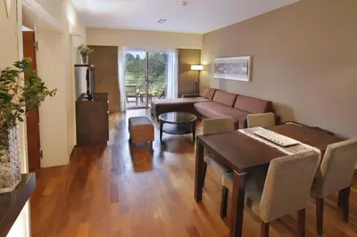 a living room with a couch and a table at Altos de Belgrano Hotel Cabañas Golf y Spa in Villa General Belgrano