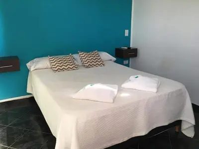 a bed with two towels on top of it at Atenea in Villa Carlos Paz
