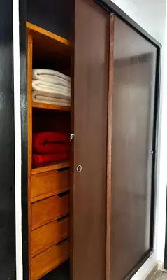a closet with a wooden door and some towels at Atenea in Villa Carlos Paz