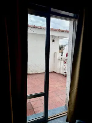 an open glass door with a view of a patio at Atenea in Villa Carlos Paz