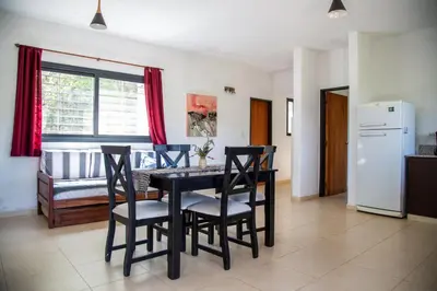 a kitchen and dining room with a table and chairs at Cuesta los Robles -Casas Serranas- in Villa Icho Cruz
