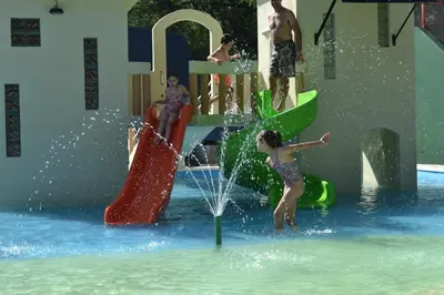 a group of people playing in a water park at Cabañas Alpendorf in Villa General Belgrano