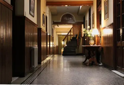 a hallway with stairs and a vase on a table at Cordoba Yolanda Hotel in Cordoba