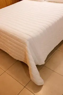 a white mattress sitting on top of a floor at Cordoba Yolanda Hotel in Cordoba
