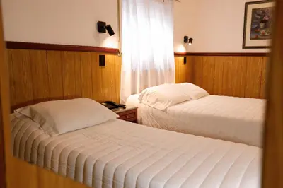 a hotel room with two beds and a window at Cordoba Yolanda Hotel in Cordoba