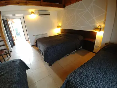 a bedroom with two beds in a room at Posada Mia Nonna in Villa General Belgrano