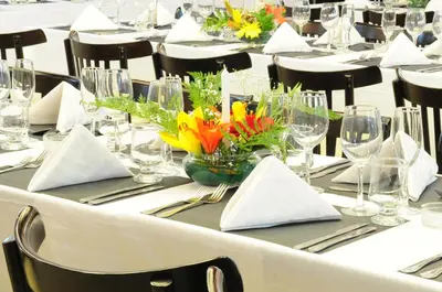a long table with flowers in a vase on it at Parque Hotel in Villa Carlos Paz