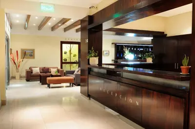 a lobby of a hotel with a reception desk at Parque Hotel in Villa Carlos Paz
