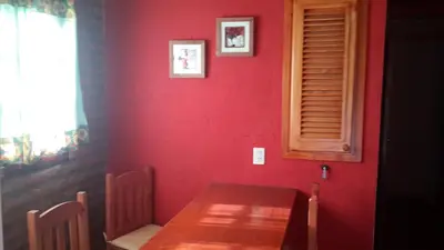 a red room with a wooden table and a red wall at Casa Loft Rumipal in Villa Rumipal