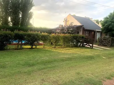 a yard with a house and a fence in front of a house at Casa Loft Rumipal in Villa Rumipal