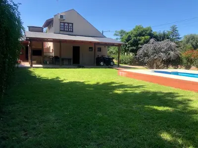 a house with a yard with a swimming pool at Casa Loft Rumipal in Villa Rumipal