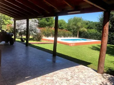 a patio with a view of a swimming pool at Casa Loft Rumipal in Villa Rumipal