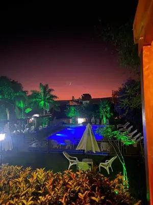 a patio with a table and chairs at night at Candy Apart Hotel in Villa General Belgrano