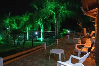 a resort with green lights in the night at Candy Apart Hotel in Villa General Belgrano