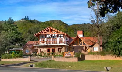 a house on the side of a road at Candy Apart Hotel in Villa General Belgrano