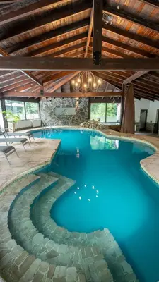 a swimming pool with blue water in a house at Posada del Sauce in Villa General Belgrano