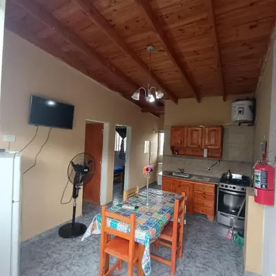 a kitchen with a table and chairs in a room at Bosquecito de Carpin in Carpintería