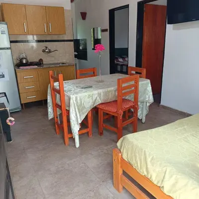 a kitchen with a table and chairs and a kitchen with a kitchen at Bosquecito de Carpin in Carpintería