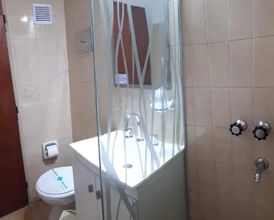 a bathroom with a shower with a sink and a toilet at Hotel Mirador de las Sierras in Villa Carlos Paz