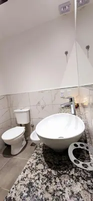 a bathroom with a white tub and a toilet at Hotel Mirador de las Sierras in Villa Carlos Paz