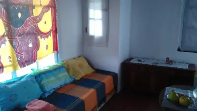 a childs room with a bed and a window at La Cima Alta Gracia in Alta Gracia