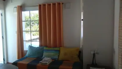 a bedroom with a window and a bed with pillows at La Cima Alta Gracia in Alta Gracia