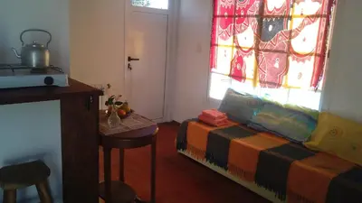 a living room with a couch and a stained glass window at La Cima Alta Gracia in Alta Gracia
