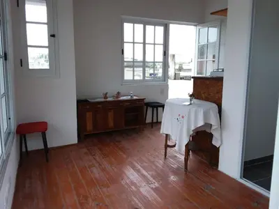 a room with a table with a white table cloth on it at La Cima Alta Gracia in Alta Gracia