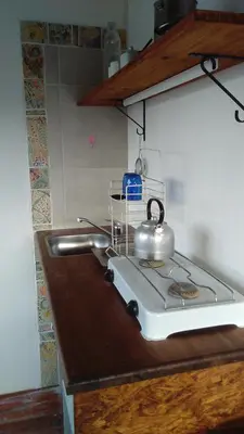 a tea kettle on top of a stove in a kitchen at La Cima Alta Gracia in Alta Gracia