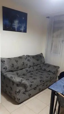 a couch in the corner of a living room at mi depto en cba in Cordoba
