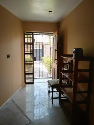 a room with a door and a chair and a table at Al lado in Cordoba